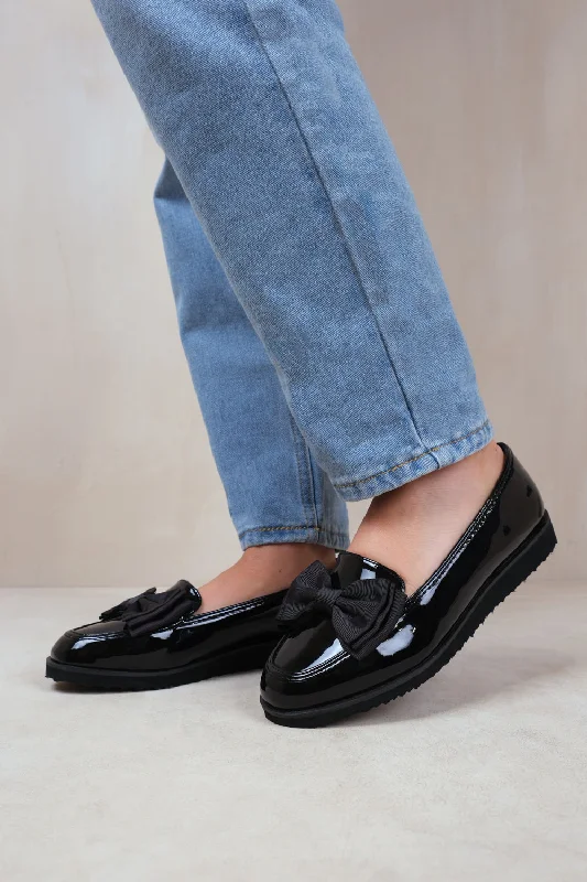 Men's loafers in a neutral color like black or brownALPHA WIDE FIT SLIP ON LOAFER SLIDER WITH BOW DETAIL IN BLACK PATENT FAUX LEATHER Men's loafers in a neutral color like black or brownALPHA WIDE FIT SLIP ON LOAFER SLIDER WITH BOW DETAIL IN BLACK PATENT FAUX LEATHER