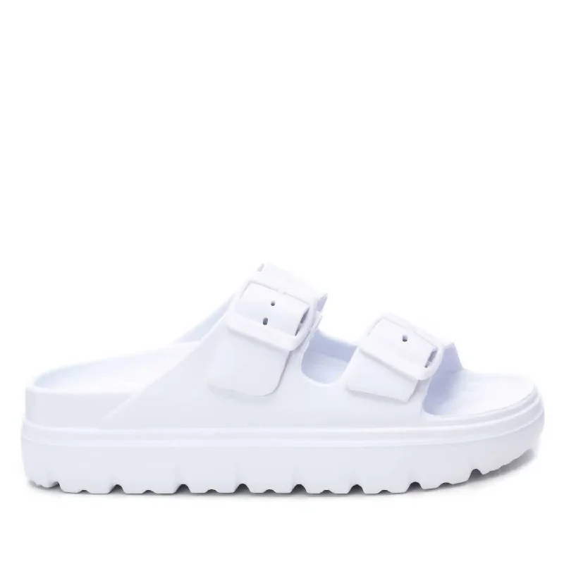 Women's Flat Slide Sandals with a Memory Foam Insole in White for All - Day Comfort Women's Flat Slide Sandals with a Memory Foam Insole in White for All - Day Comfort Waterproof Women's Rubber Beach Sandals with Arch Support in Blue for Water ActivitiesWomen's Buckle Strap Sandal In White